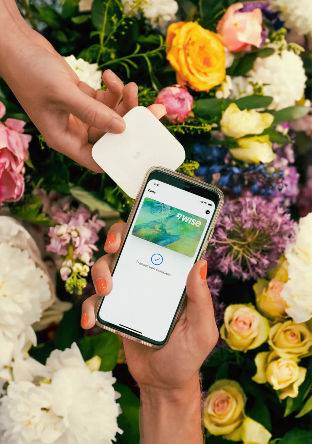 A customer pays in a florist. They use their Wise digital card on their phone.