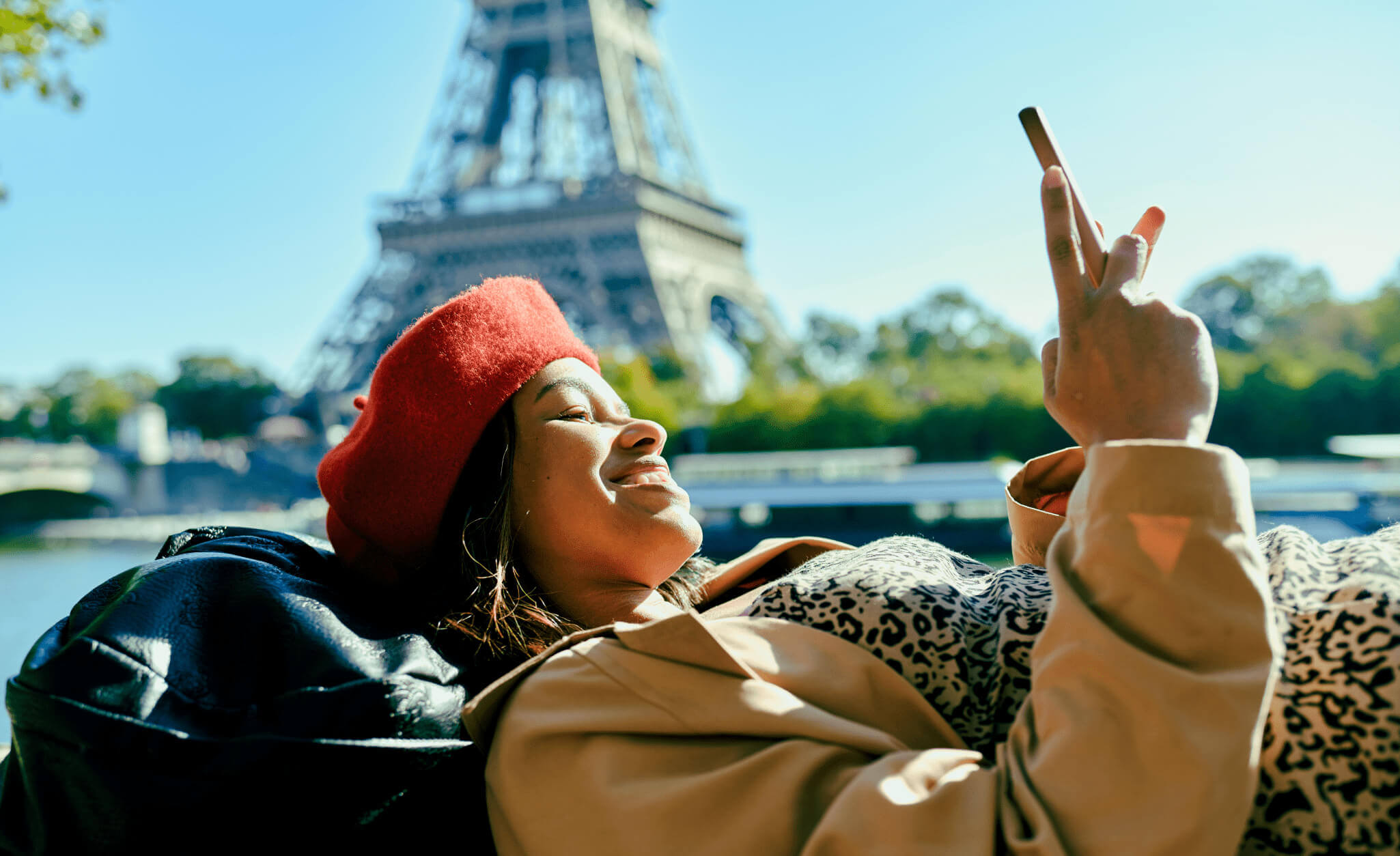 Brazilian Woman on her phone in front of the Eiffel tower